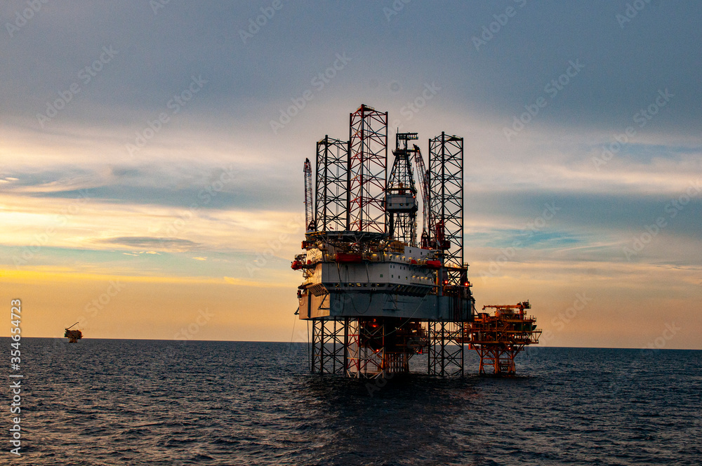 Wall mural oil drilling rig at sunset