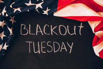 Fototapeta na wymiar Blackout tuesday inscription on a black background with american flag around. Black lives matter, blackout tuesday2020 concept.