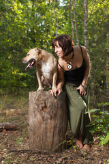 Beautiful women and dog in forest summer time 