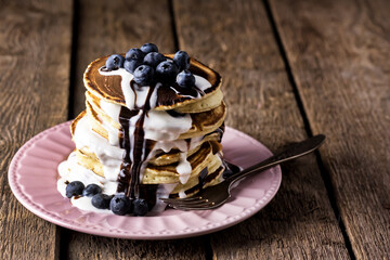 Stack of Pancakes with Fresh Blueberry and Cream Tasty Breakfast Wooden Table Horizontal Copy Space Dark Photo