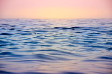Naklejka na ściany i meble Seascape background colorful sea waves at sunset