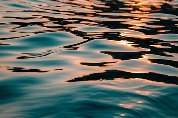 Fototapeta na wymiar Seascape background sun's rays reflect on sea surface at sunset