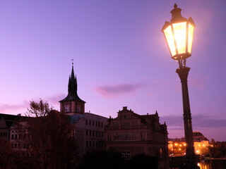 Ancient European houses in Prague. City landscape. The dim light of a street lamp.