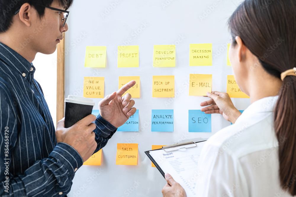 Poster two creative business people meeting and planning use notes sticky note on white board to share idea