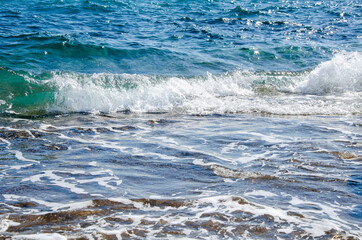 Seascape background white waves on blue sea
