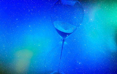 Hour glass suspended in starts to illustrate time and space