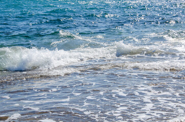 Seascape background white waves on blue sea