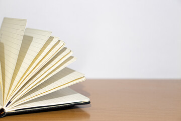 Open notebook on a wooden table