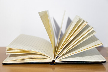 Open notebook on a wooden table