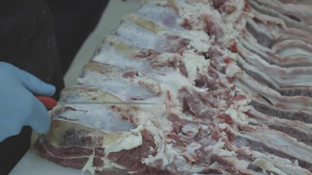butcher is cutting meat