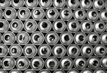 Empty aerosol cans in production factory awaiting filling with products