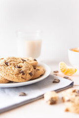 Chocolate chip cookies, tangerine and milk