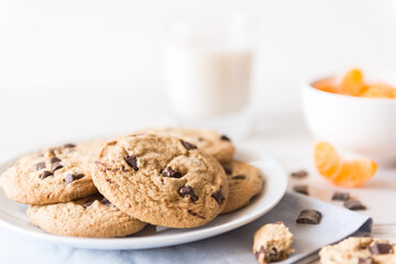 Chocolate chip cookies, tangerine and milk