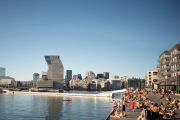 Panorama view on Oslo downtown. Sunny summer day, people enjoying sun, view on Oslo Opera House,...