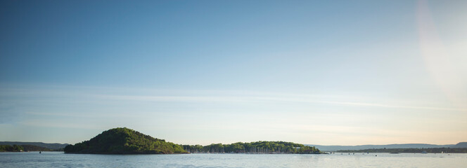 Summer view of a sea, island and a clear blue sky.