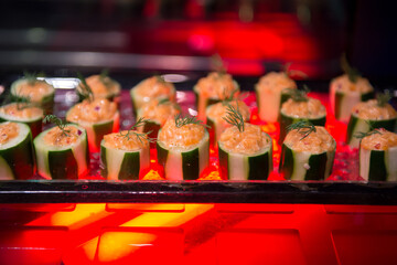 miced salmon stuff in cucumber canapes on slate platter