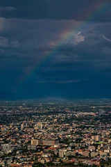 Foto op Canvas CHIANG MAI, THAILAND - May 27,2020: Aerial Panorama View of Chiang Mai City with rain cloud and rainbow, Thailand © somchairakin