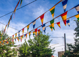 Festive striped triangular flags are hung on the street.