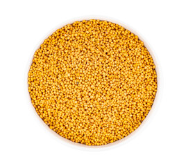 mustard seeds in bowl isolated on white background
