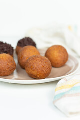 Deep fried bunuelos balls. Creative minimalist composition on a white background.
