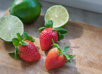 Fototapeta na wymiar Fruit on the wooden table. Apple, lime, lemon, strawberry. 
