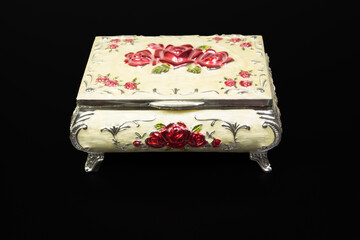 a metal colored casket for jewelry stands on a black background. Box. 