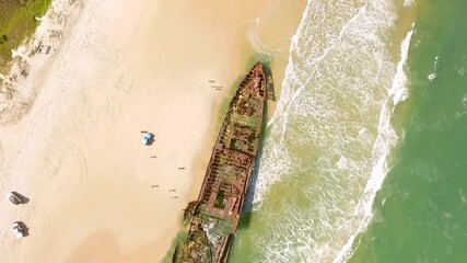An aerial view shows people approaching an old shipwreck that has washed ashore on Fraser Island, off the coast of Queensland, Australia.