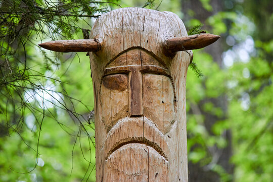 The image of the Slavic deity Veles carved from a tree trunk on a neo-Pagan temple in the forest. Kaluzhskiy region, Russia. Veles - the god of cattle breeding, wealth and wisdom
