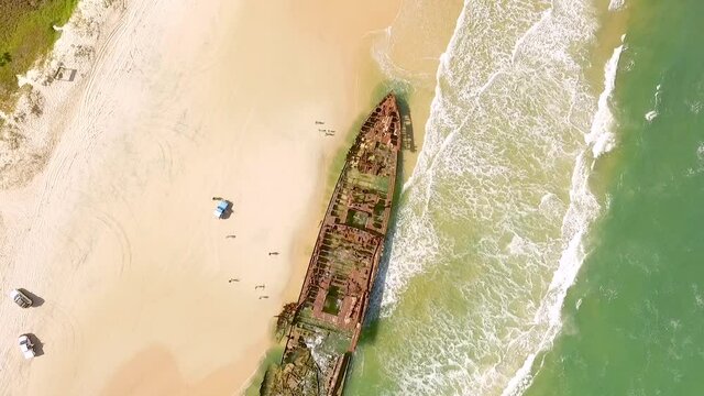 An aerial view shows people approaching an old shipwreck that has washed ashore on Fraser Island, off the coast of Queensland, Australia.