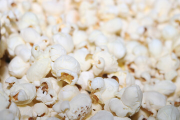 popcorn on a white on pop corn bucket 