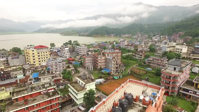 An aerial view shows the mountains and the city of Pokhara, Nepal on Phewa Lake.