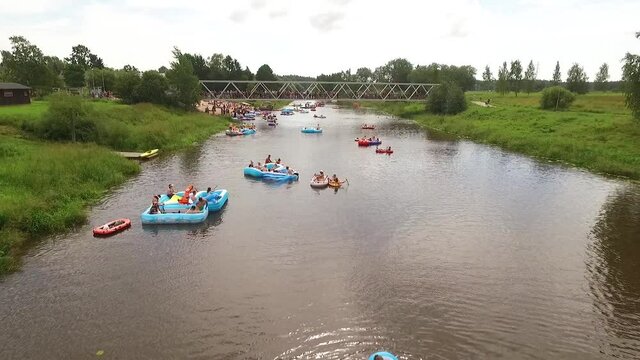 People of all ages participate in Kaljakellunta, the beer floating festival in Finland, riding on inflatable boats and inner tubes down a river.