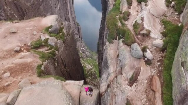 An aerial view shows a couple standing on Kjeragbolten, a boulder on the Kjerag mountain in Rogaland, Norway.