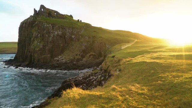 The Duntulm Castle ruins are seen at sunset on the Isle of Skye in Scotland.