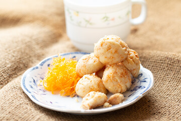 Golden cookies balls with eggs silk for tea time in morning in white plate