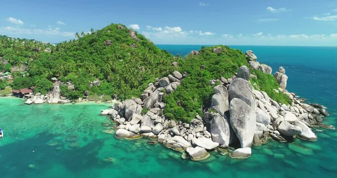 An aerial view shows palm trees growing among rocks on Ko Thao, Thailand.