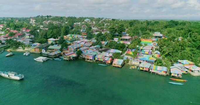 An aerial view shows the colorful buildings and boats of Rainbow Village on the Kai Islands, Indonesia.
