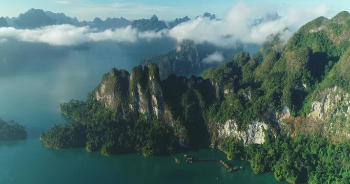An aerial view shows green mountains and harbor lodgings among the clouds at Khao Sok National Park in Surat Thani, Thailand.