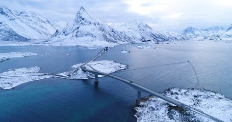 Cars drive over bridges connecting the wintry Lofoten Islands in Norway.