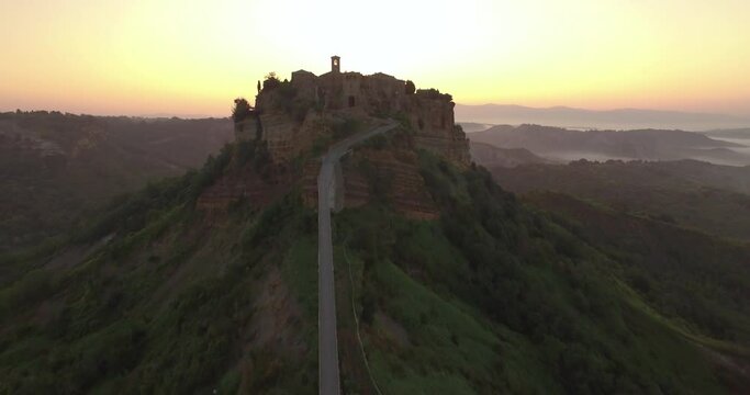 An aerial view shows Civita di Bagnoregio, Italy at sunset.