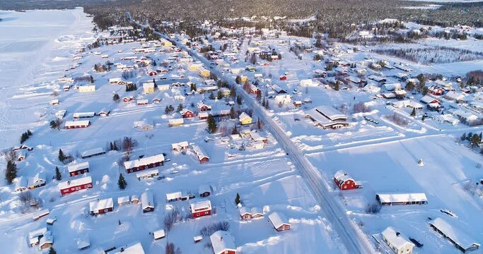 An aerial view shows the colorful homes near a forest in the wintry town of Kiruna, Sweden.