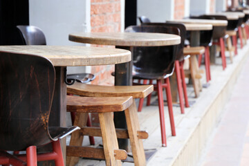 Street cafe, empty tables and vintage wooden chairs in a restaurant outdoor. City business during coronavirus pandemic