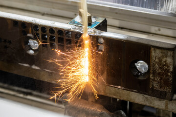 The sparking light from wire-EDM machine. The operation of wire-cut machine.