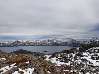 snowy mountain landscape and sea in nordkapp in early spring