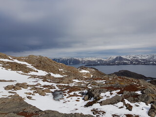 Fototapeta na wymiar snowy mountain landscape and sea in nordkapp in early spring