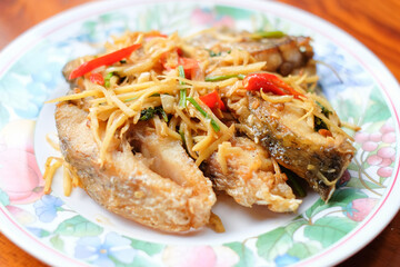 Close up stir-fried spicy sea bass with finger root - homemade Thai food concept.