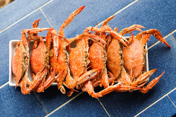 The steamed crab (claws) serve on white dish - homemade food concept.