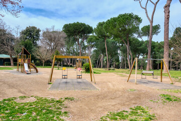 Fototapeta premium Rome, Italy - March 2020: Empty child's playground in Villa Borghese. Sadness of an empty children's playground, normally very busy with kids playing. Another face of the COVID-19 epidemic in Italy