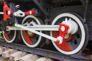 Wheels of an old steam locomotive. An old steam locomotive. Red locomotive wheels.