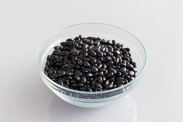 A Transparent Bowl of Dried Raw Black Beans